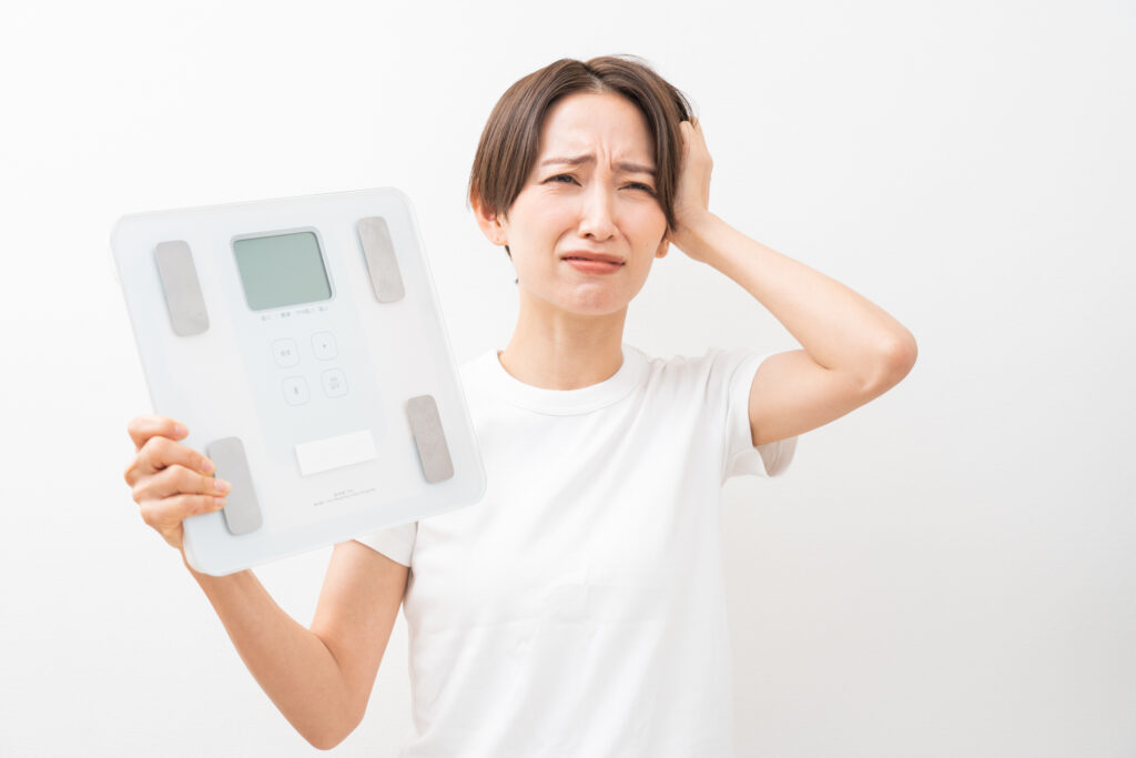 体重計の数値を確認する女性